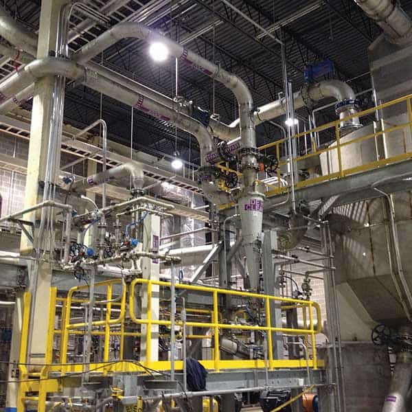 Industrial pipes and machinery in a factory setting.